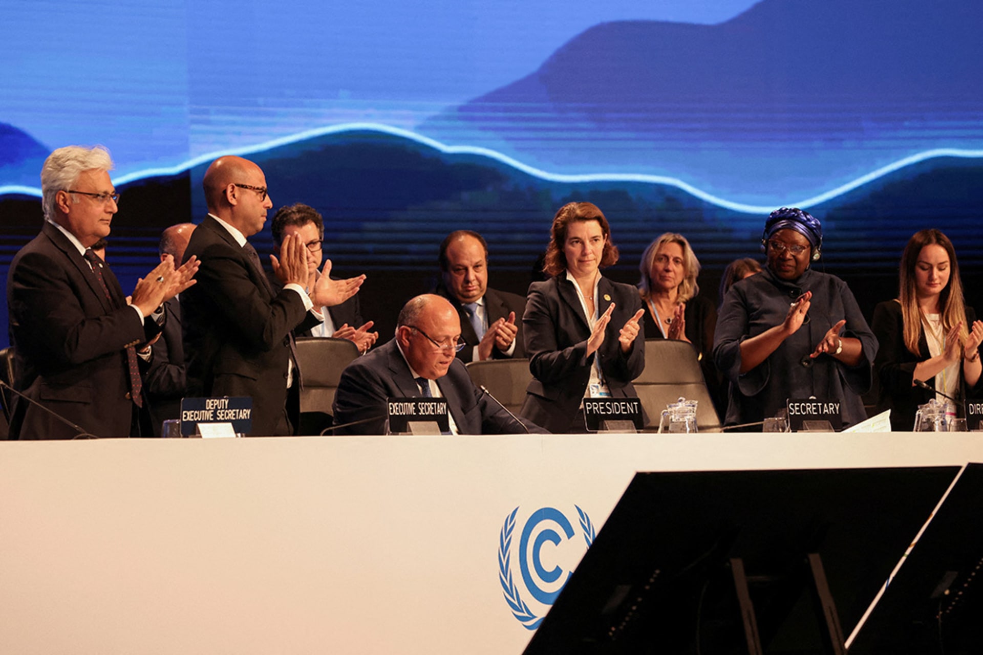Delegates applaud as COP27 President Sameh Shoukry delivers a statement at the end of the conference. Mohamed Abd El Ghany/Reuters