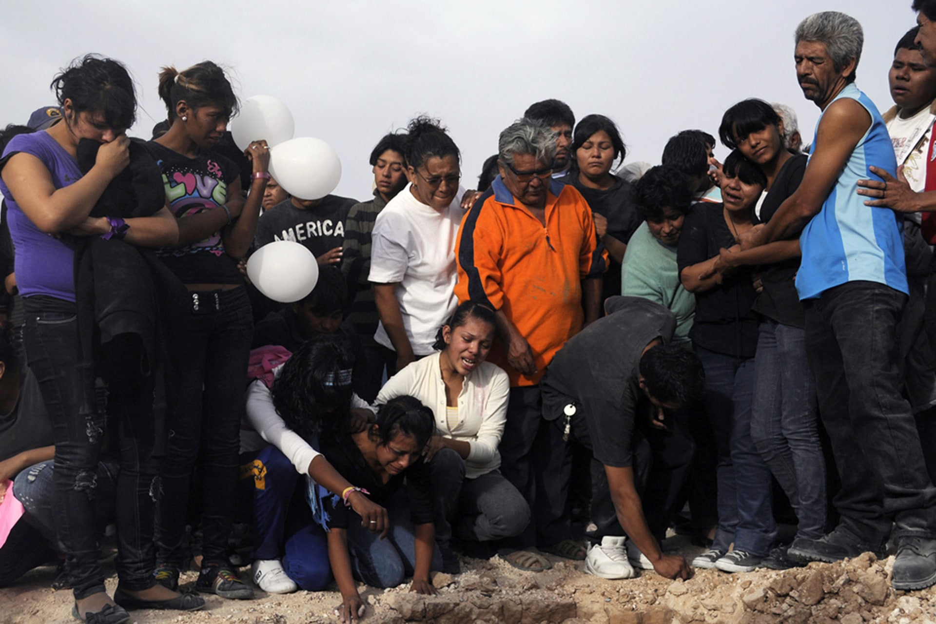 Family and friends mourn the victims of those killed at a birthday party in Ciudad Juárez in October 2010. Gael Gonzalez/Reuters