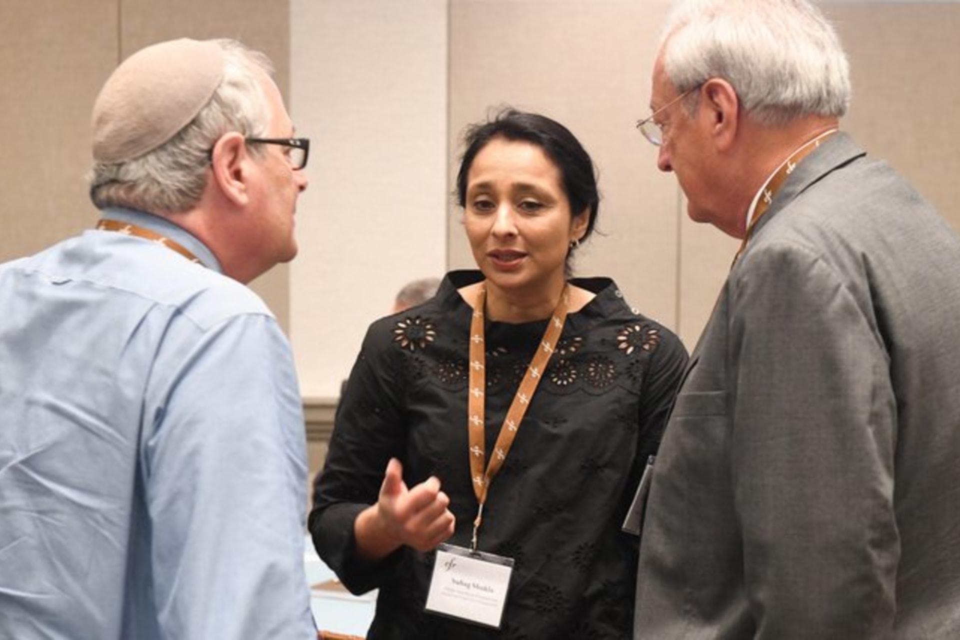 Three people talking during Religion Program meeting