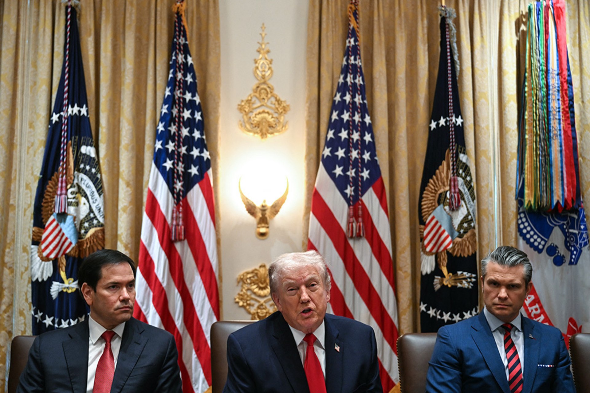 US President Donald Trump speaks alongside Secretary of State Marco Rubio (L) and Defense Secretary Pete Hegseth (R) during a cabinet meeting in the Cabinet Room of the White House in Washington, DC, on January 29, 2026.