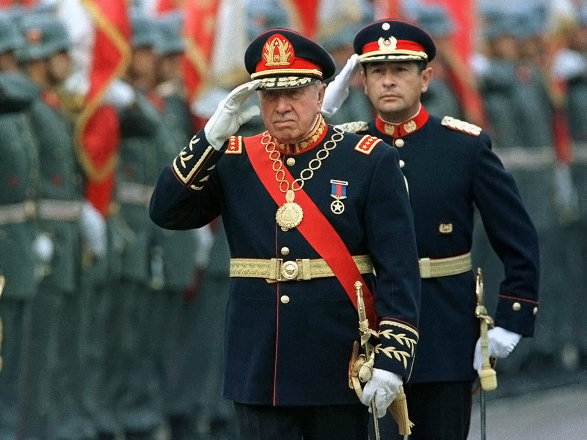 Former Chilean dictator Augusto Pinochet salutes troops at the Military School in Santiago.