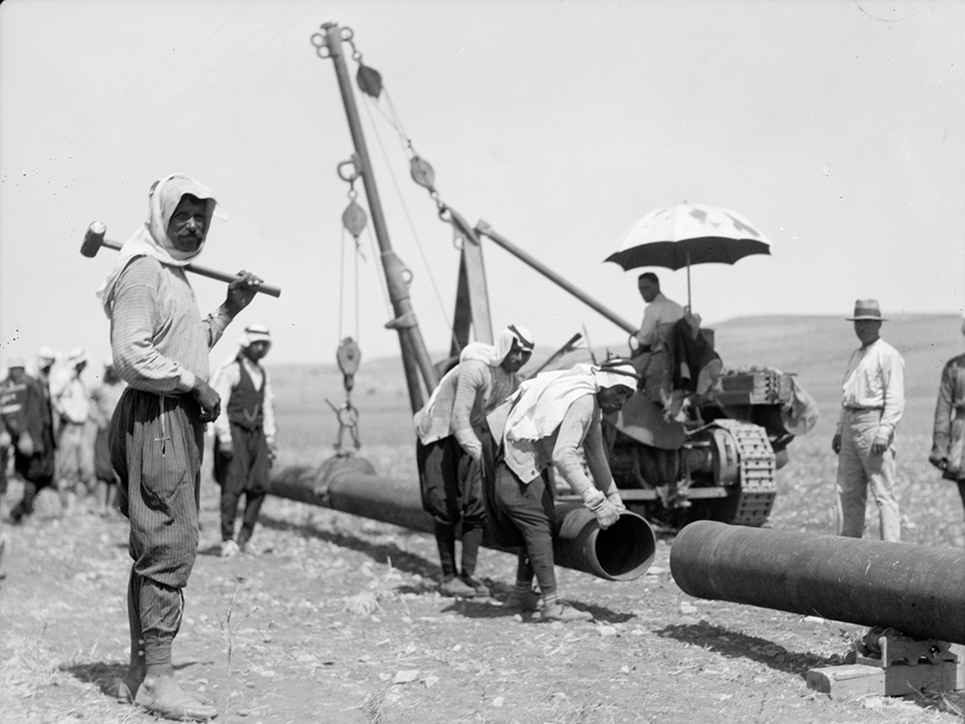 Workers for the Iraq Petroleum Company connect an oil pipeline in July 1933.