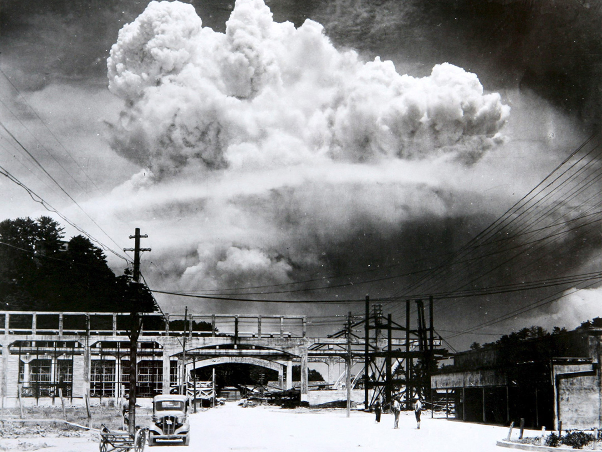 A mushroom cloud from the atomic bomb rises over Nagasaki.