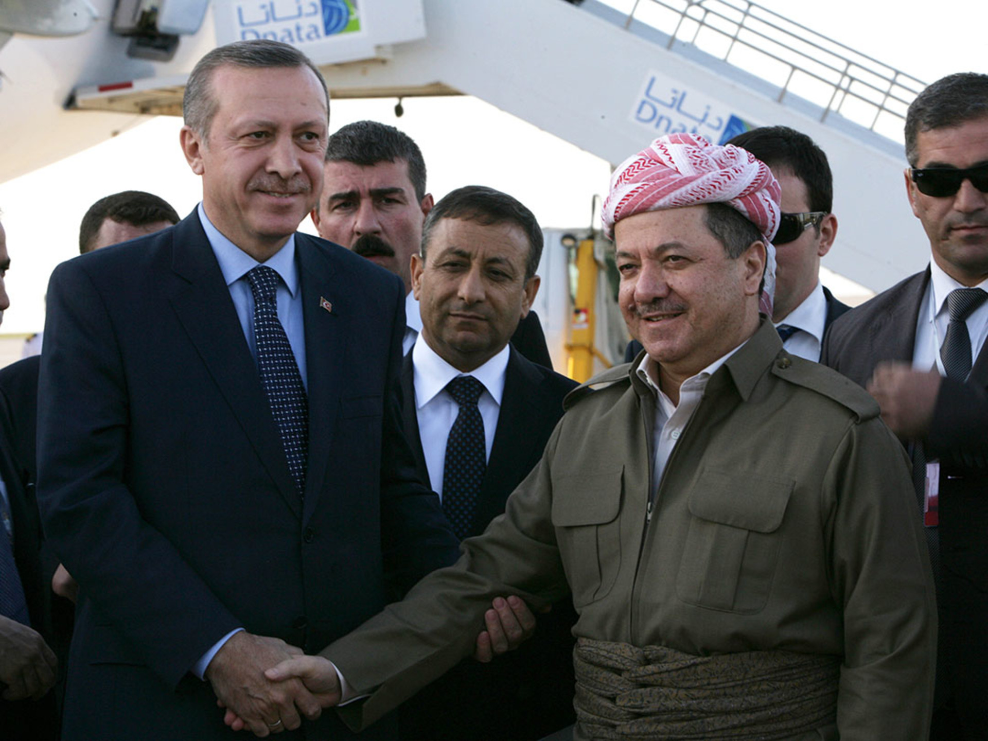 Turkish Prime Minister Recep Tayyip Erdogan and Kurdish President Masoud Barzani shake hands at Erbil International Airport in March 2011. 