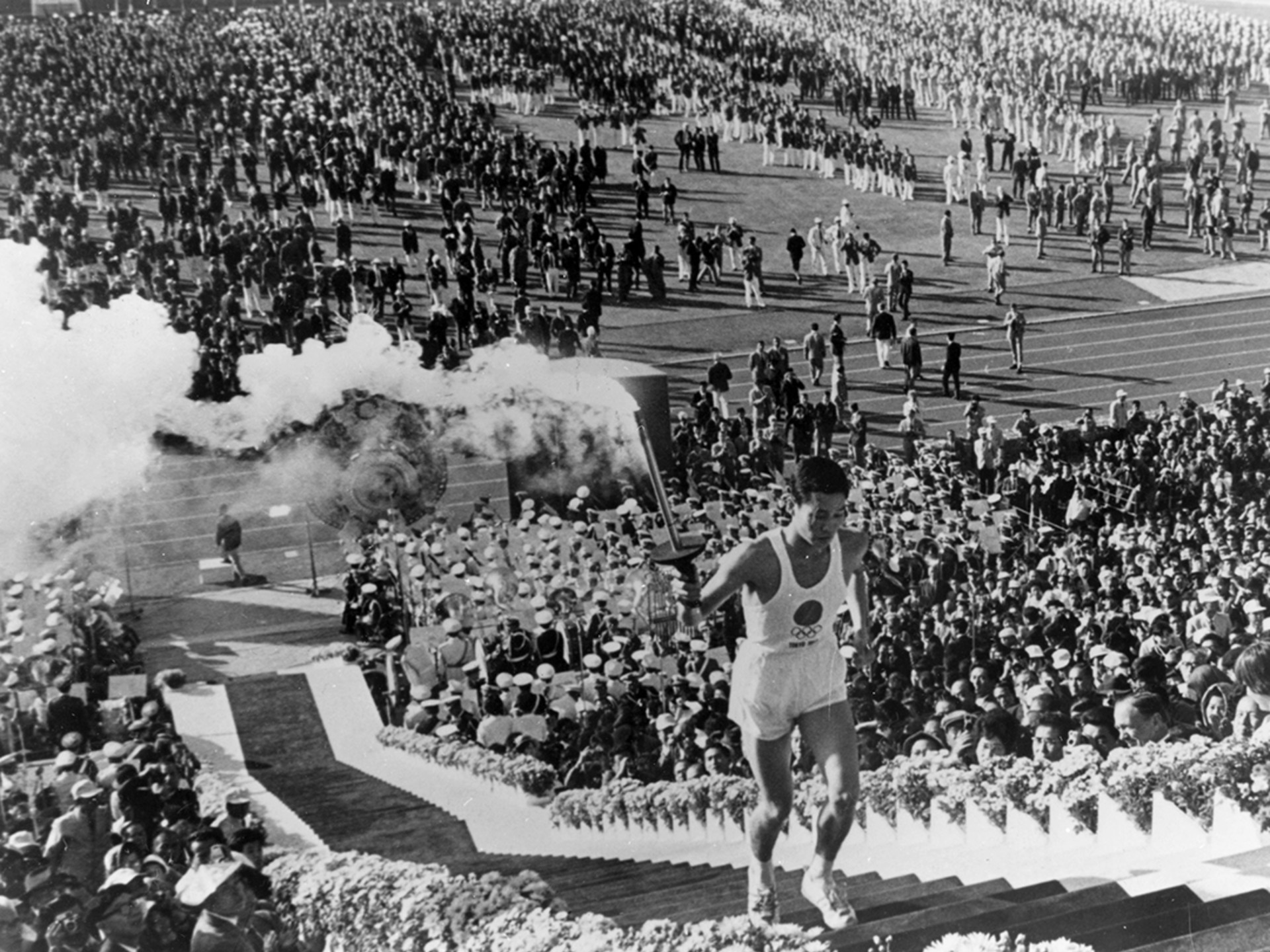 Yoshinori Sakai, a student at Waseda University, carries the Olympic torch during the opening ceremony in Tokyo. Keystone-France/Gamma-Keystone/Getty Images