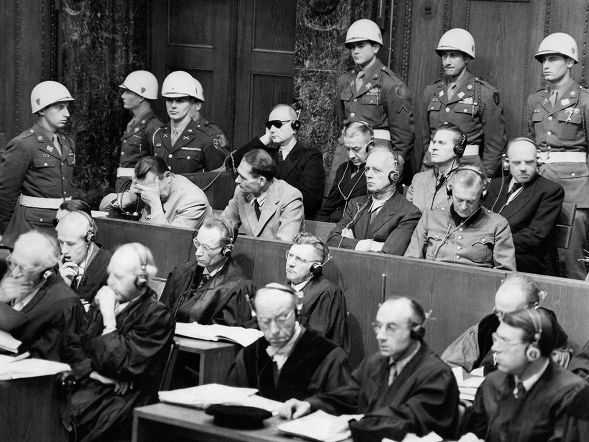 High-ranking Nazi defendants sit in the dock of the courtroom at the Nuremberg war crimes trials.