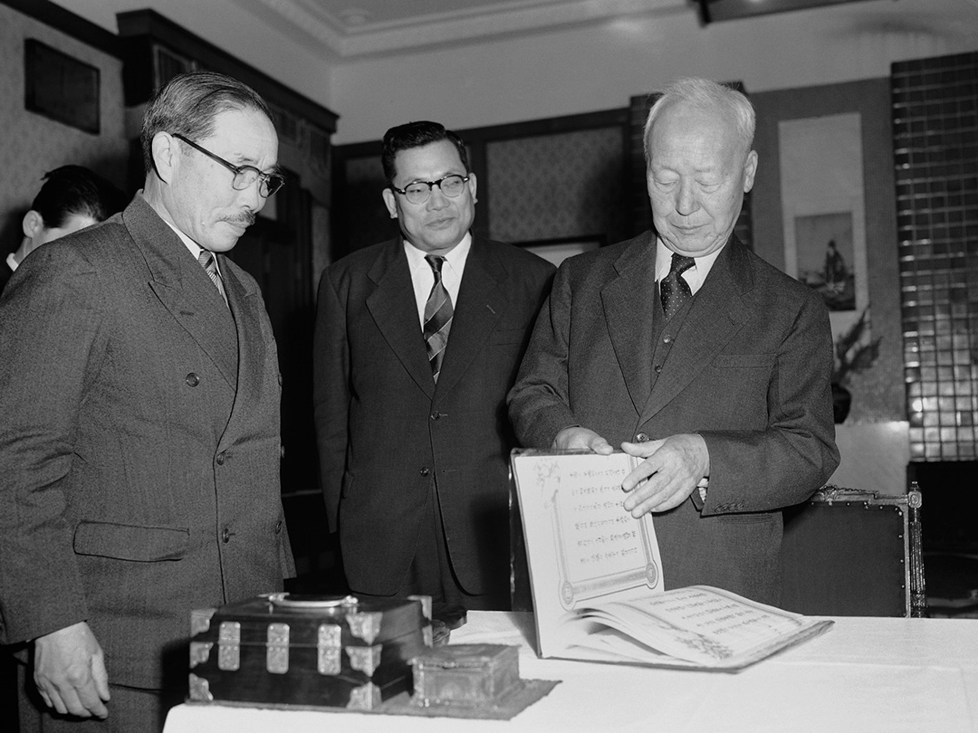 South Korean President Rhee Syngman leafs through the mutual defense treaty between the United States and Republic of Korea on January 29, 1954. George Sweers/AP Photo