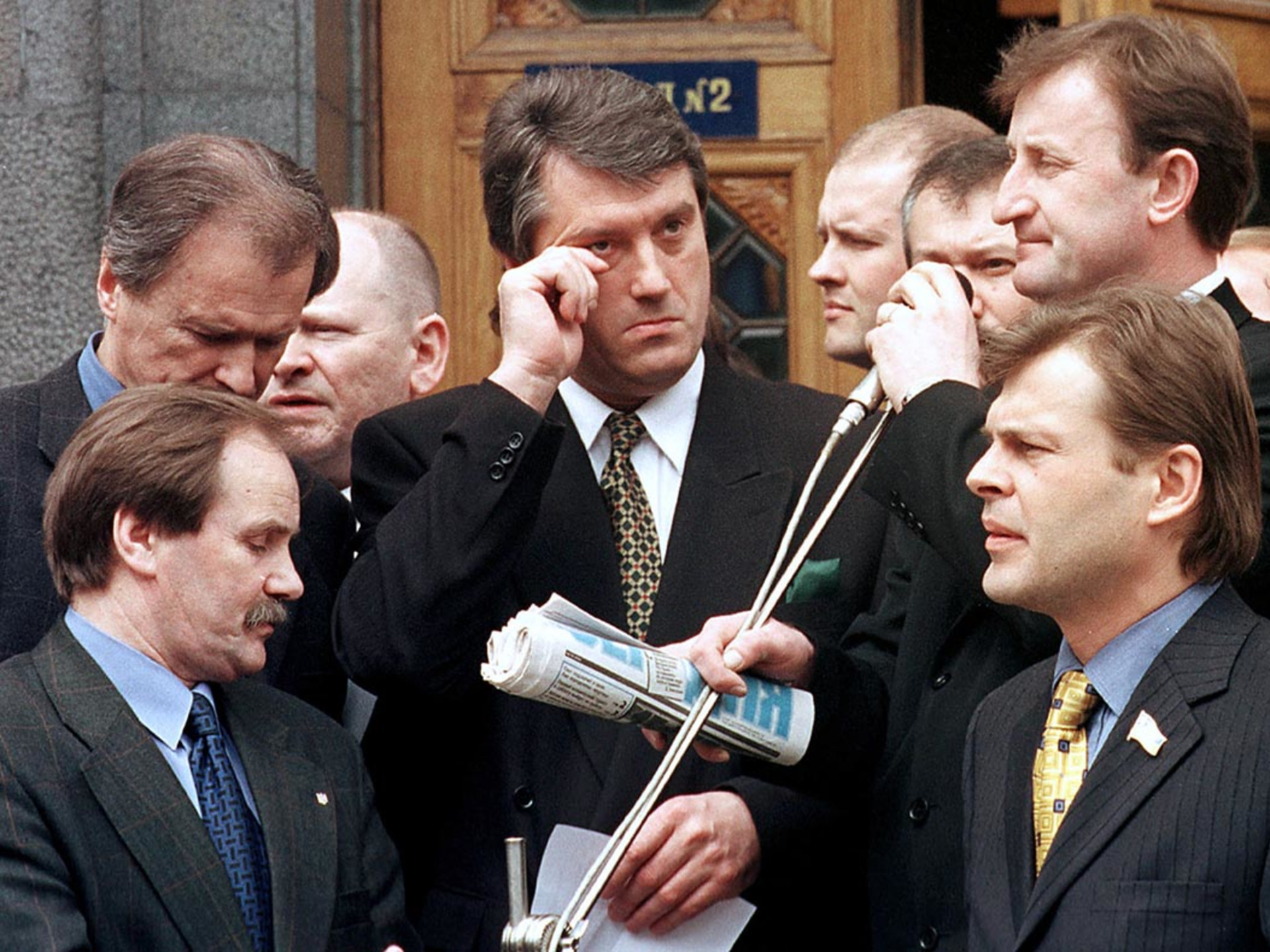 Outgoing Prime Minister Viktor Yushchenko, surrounded by deputies, prepares to address a crowd of supporters.